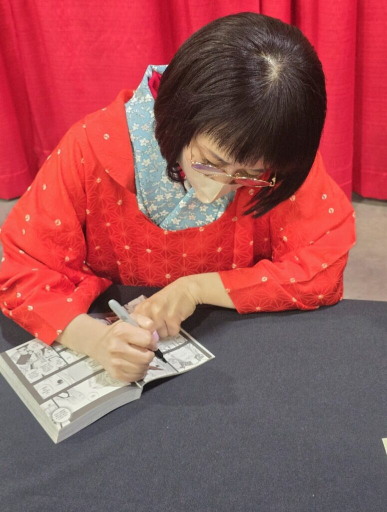 Misa Watanabe signing manga at Anime Weekend Atlanta 2024