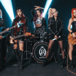 Rolling Quartz standing with their instruments in front of a dark background