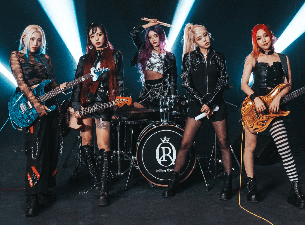 Rolling Quartz standing with their instruments in front of a dark background